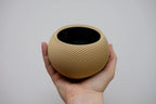 Sfera Collection 2, Ondula II (left-hand twist) in beige, held in the hand