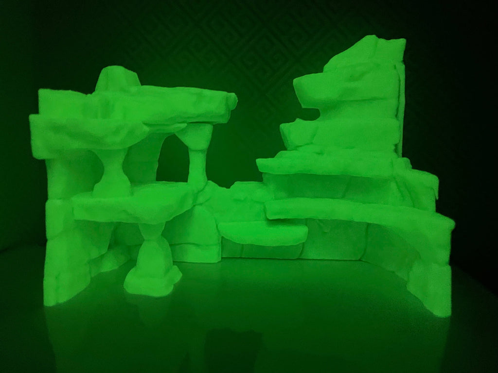Ancient Ruins Hideout photographed in a dark room, the print glowing green