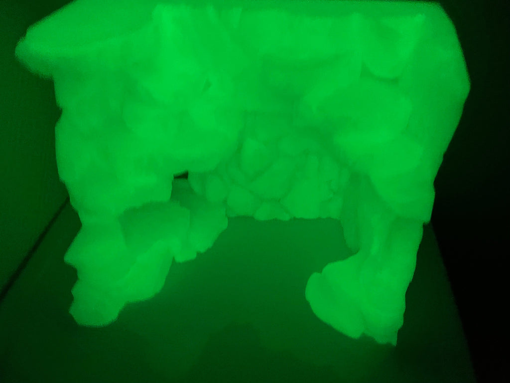 Stone Step Hideaway photographed in a dark room, the print glowing green