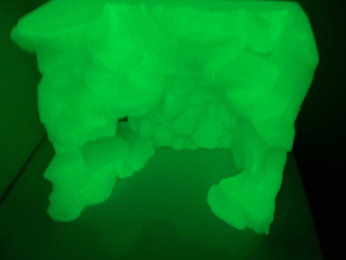 Stone Step Hideaway photographed in a dark room, the print glowing green