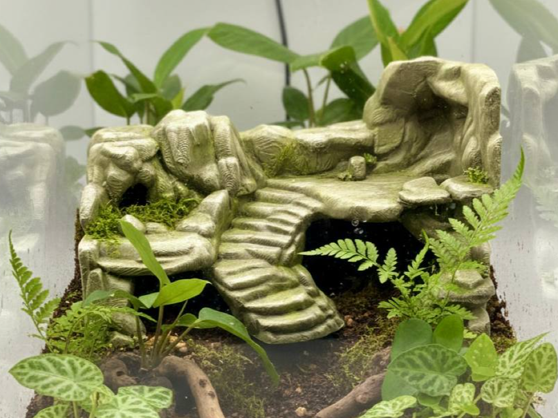 Jungle Stones background with stepped rock ledges and caves; supplied unpainted